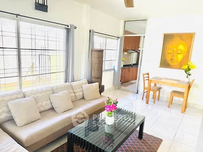 Bright living room with modern decor and open kitchen layout