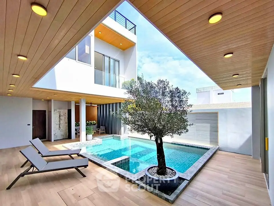 Luxurious modern home with private pool and stylish outdoor seating area.