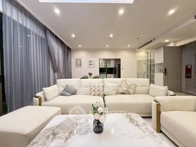 Luxurious modern living room with elegant decor and spacious seating area.