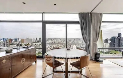 Stunning high-rise apartment with panoramic city views and elegant dining area.