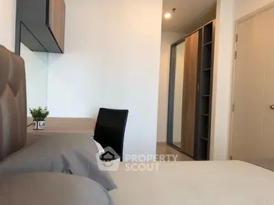 Modern bedroom with sleek furniture and ample storage space