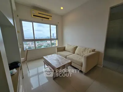 Modern living room with city view, featuring a cozy beige sofa and sleek coffee table.