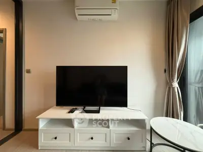 Modern living room with sleek TV setup and air conditioning, perfect for cozy relaxation.
