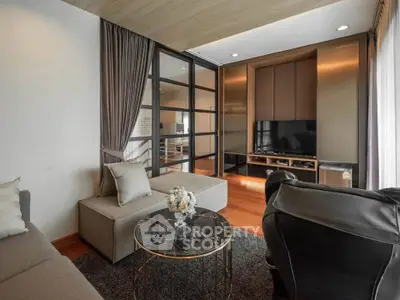 Modern living room with stylish furniture and elegant decor, featuring a cozy seating area and a sleek entertainment unit.