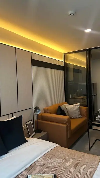 Modern bedroom with cozy seating area and stylish lighting