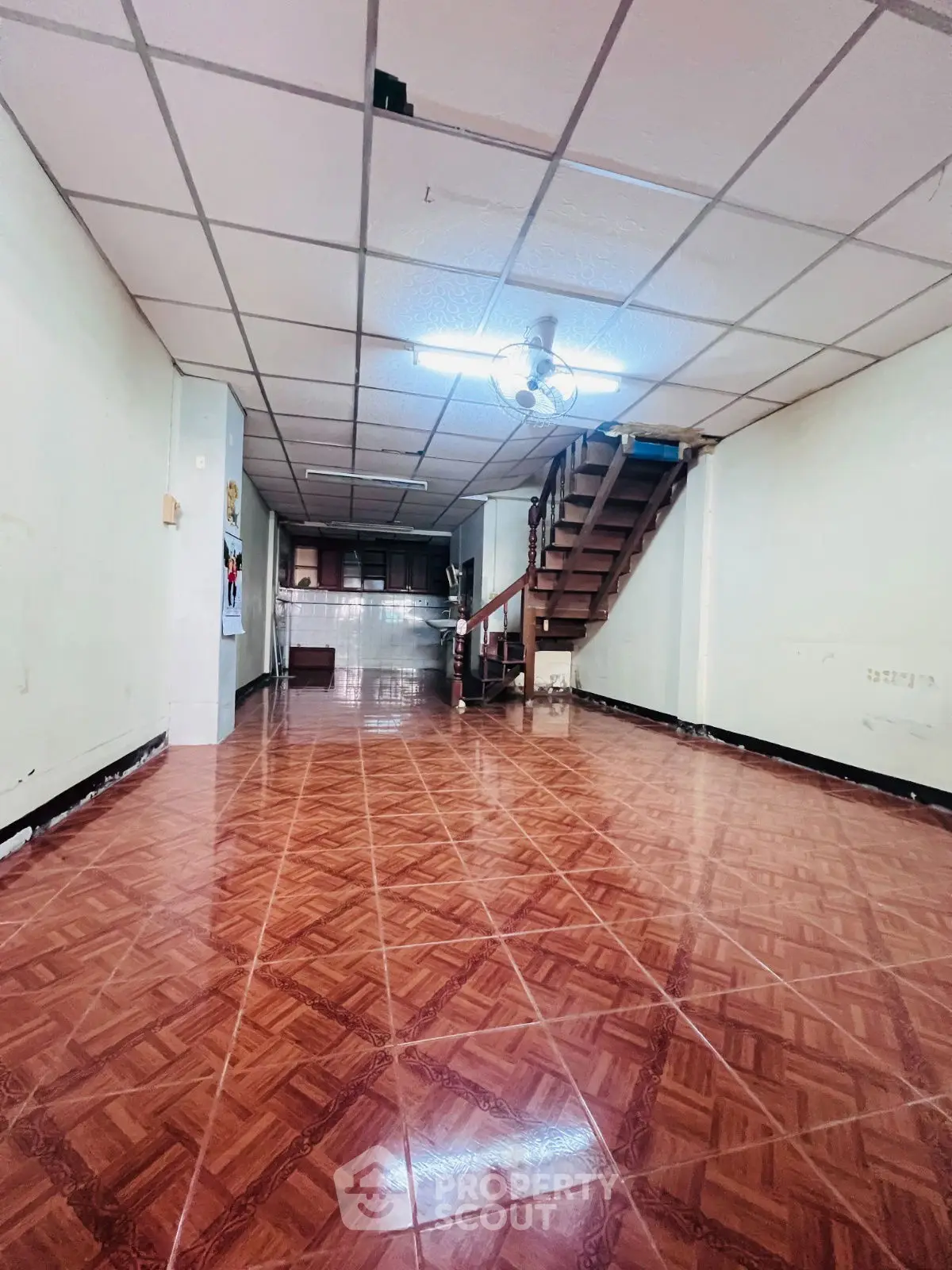 Spacious interior with wooden flooring and staircase, ideal for modern living.