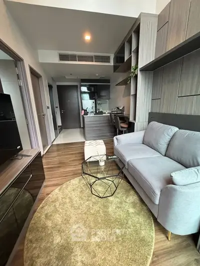 Modern living room with stylish decor and open kitchen layout in a contemporary apartment.