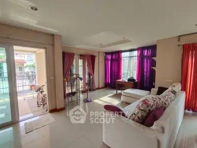 Spacious living room with vibrant curtains and natural light