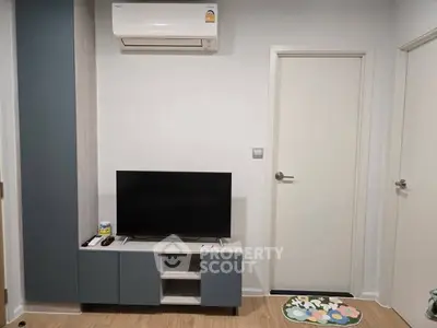 Modern living room with sleek TV stand and air conditioning unit, perfect for cozy relaxation.