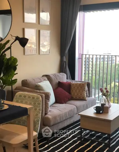 Cozy living room with stylish decor and balcony view, perfect for relaxation and entertaining.