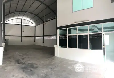 Spacious industrial warehouse with high ceiling and office space