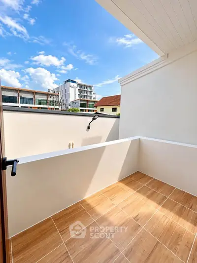 Charming balcony with modern tiles and scenic urban view, perfect for relaxation and outdoor enjoyment.