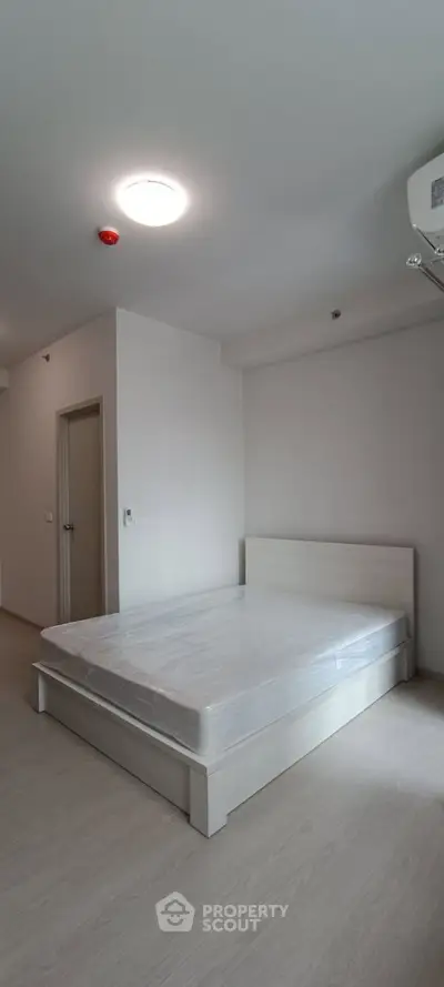 Spacious bedroom with minimalist design and natural light