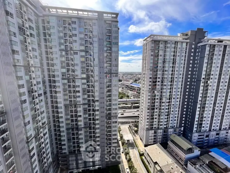 Stunning high-rise residential buildings with panoramic city views under a clear blue sky.