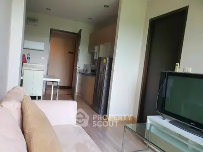 Spacious living room seamlessly connects to a modern kitchen, featuring ample natural light and contemporary design, ideal for comfortable urban living.