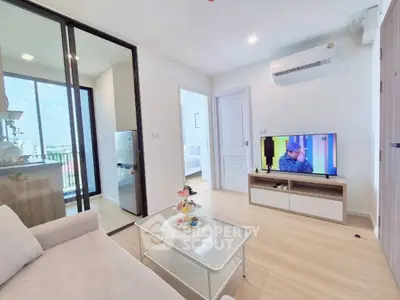 Modern living room with sleek design, open layout, and balcony view in a stylish apartment.
