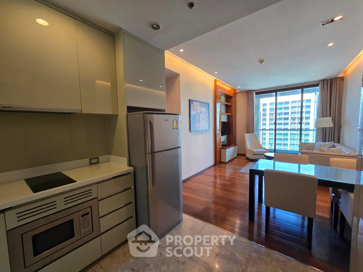 Modern open-layout kitchen and living room with sleek design and large windows offering city views.