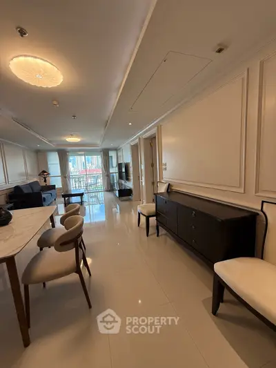 Spacious modern living room with elegant furniture and large windows offering natural light.