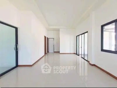 Spacious modern interior with large windows and sleek tile flooring, perfect for customization.