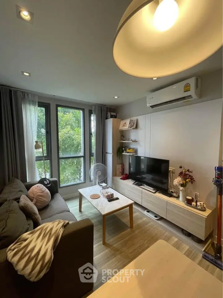 Cozy modern living room with large window and stylish decor