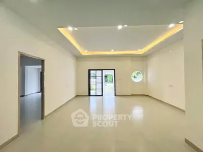 Spacious modern living room with recessed lighting and large windows