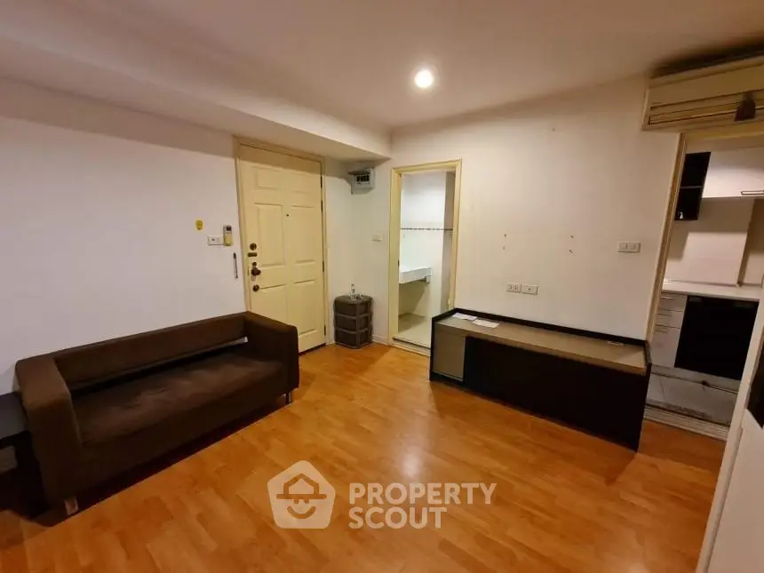 Cozy living room with wooden flooring and modern furniture in a stylish apartment.