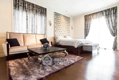 Luxurious bedroom with elegant decor and spacious layout, featuring a plush sofa and stylish coffee table.