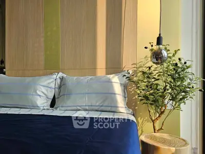 Cozy bedroom with stylish bedding and modern lighting