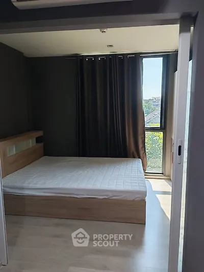 Modern bedroom with large window and minimalist design