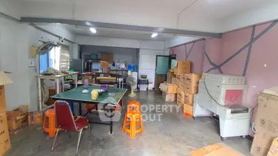 Spacious storage room with ample shelving and boxes, ideal for organizing and storing items efficiently.