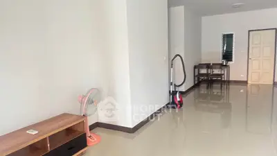 Spacious living area with glossy tiled floors and minimalist furniture in modern apartment.