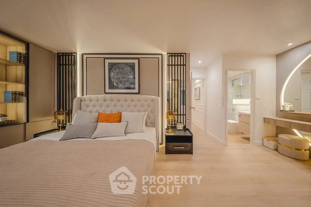 Luxurious bedroom with elegant decor and modern lighting, featuring a plush bed and stylish furnishings.