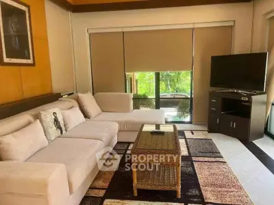 Spacious living room with modern decor and large windows offering natural light.