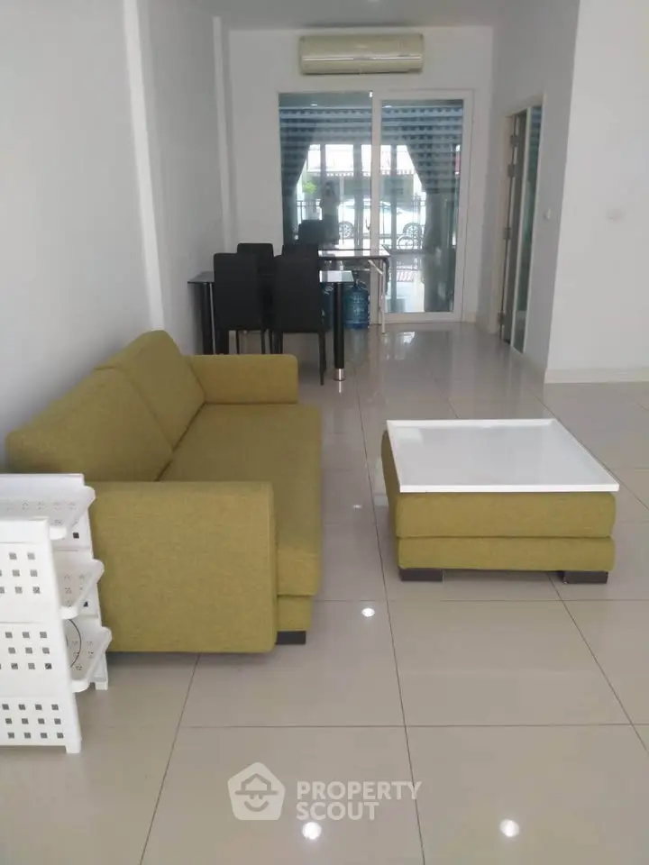 Spacious living room with modern furniture and large windows for natural light.