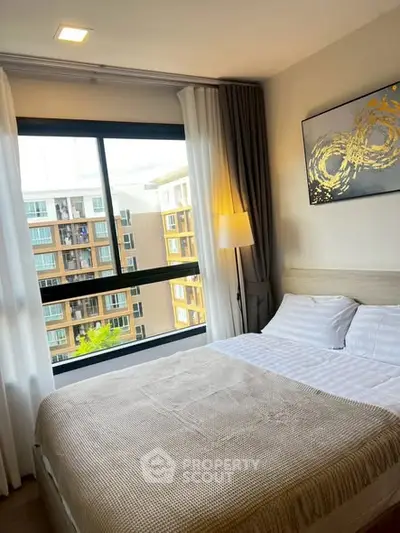 Cozy bedroom with large window and modern decor in urban apartment