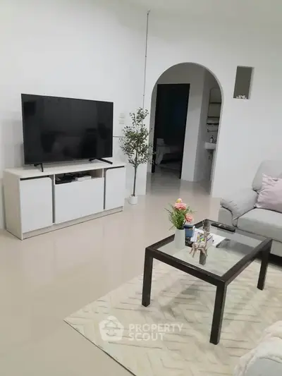 Modern living room with sleek TV setup and cozy seating area