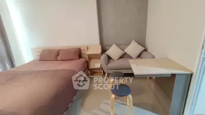 Modern studio apartment with cozy bed and compact dining area