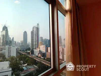 Stunning cityscape view from a modern apartment window, showcasing urban skyline and vibrant city life.