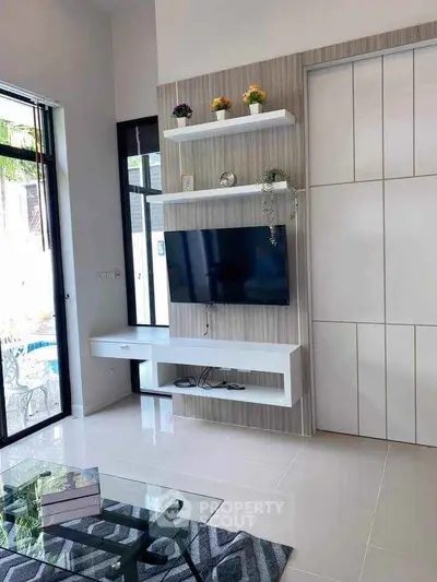 Modern living room with sleek TV unit and glass coffee table