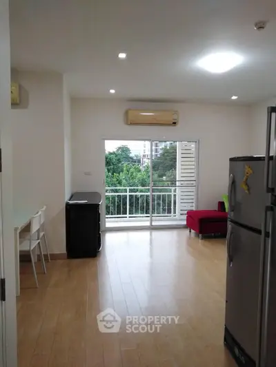 Spacious living room with balcony and modern appliances