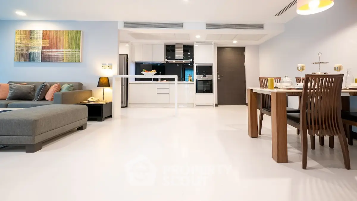 Modern open-plan living room and kitchen with stylish decor and dining area