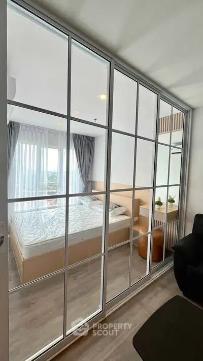 Modern bedroom with glass partition and natural light
