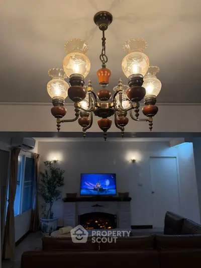 Elegant living room with vintage chandelier and cozy fireplace ambiance