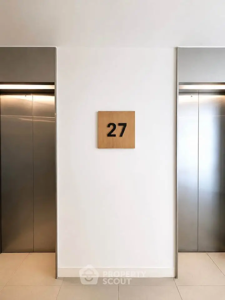 Modern elevator lobby on the 27th floor with sleek design and contemporary finishes.