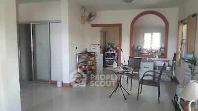 Spacious living area with modern furniture and ample natural light, perfect for relaxation and entertaining.