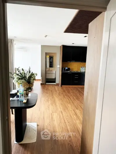 Spacious open-layout kitchen with modern black cabinetry and elegant dining area.
