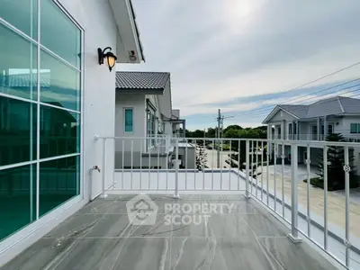 Spacious balcony with modern railing and scenic neighborhood view