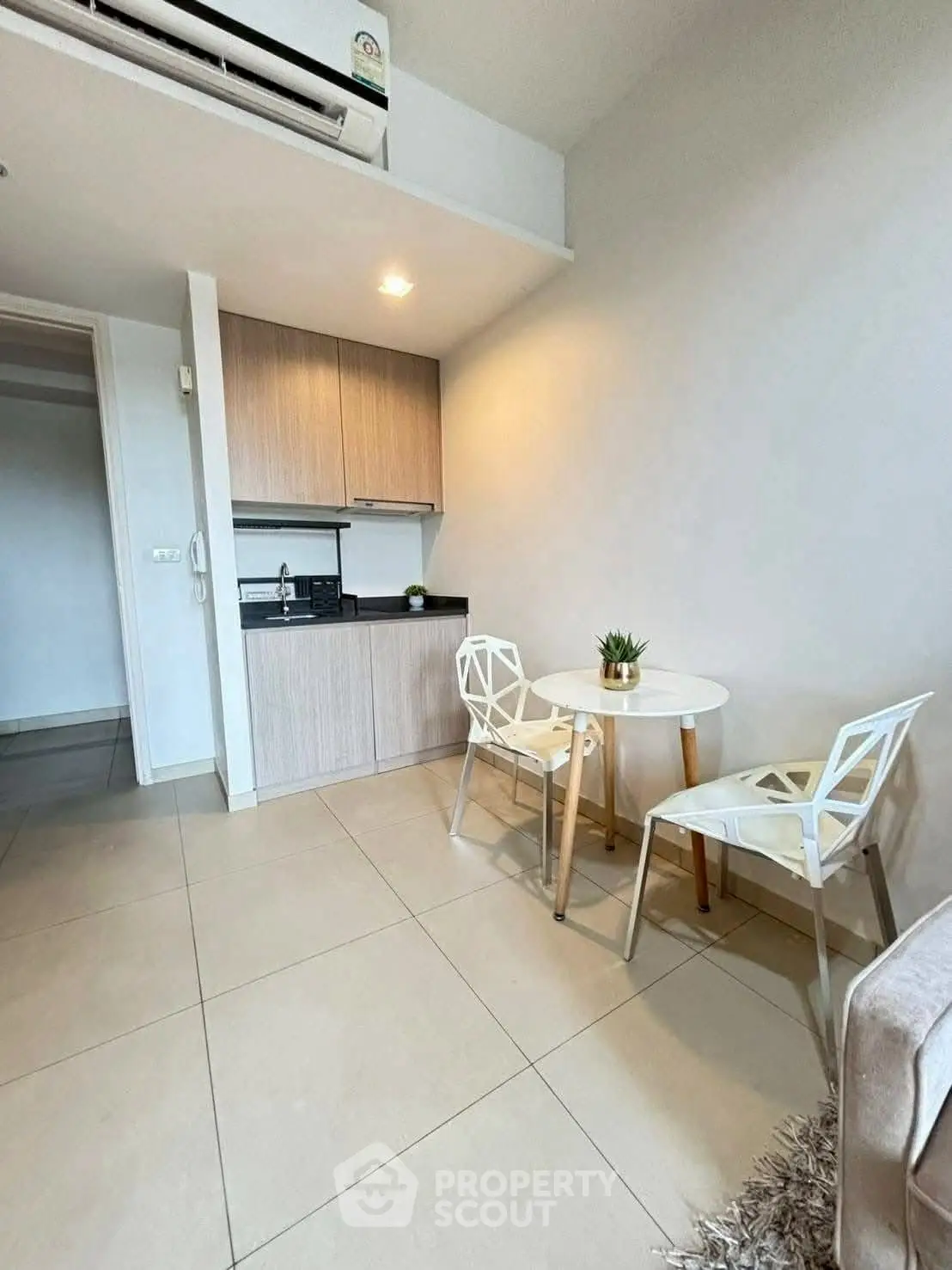 Cozy modern kitchenette with dining area in compact apartment