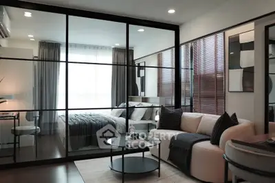 Modern living room with glass partition and stylish decor in a cozy apartment.
