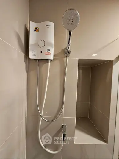 Modern bathroom with sleek shower unit and built-in shelf, perfect for contemporary living.